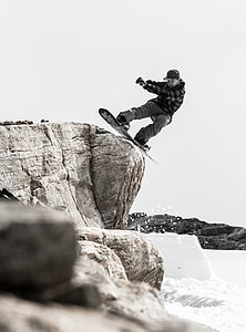 man snowboarding on cliff thumbnail