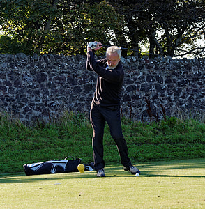man golfing during daytime thumbnail