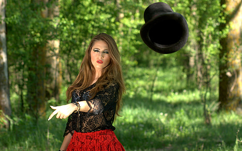 woman in black lace shirt and red skirt throw black hat thumbnail