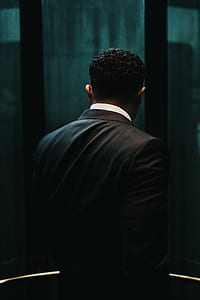 man wears black dress suit thumbnail