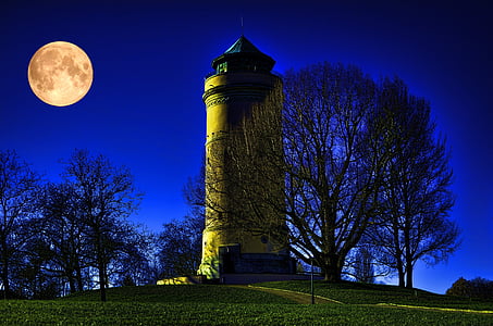 tower under full moon and calm blue sky thumbnail