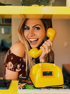 photo of woman holding yellow telephone thumbnail