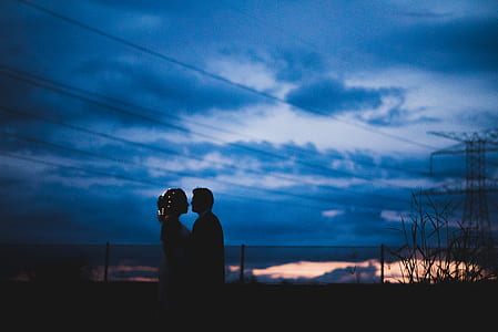 standing man and woman near light lost during golden hour thumbnail
