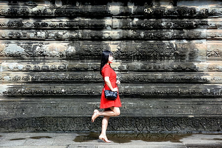 woman standing beside wall thumbnail