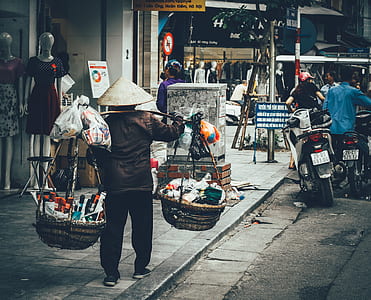 man carrying baskets thumbnail
