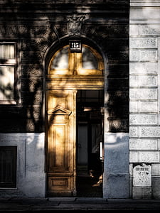 gray concrete building with brown wooden door thumbnail