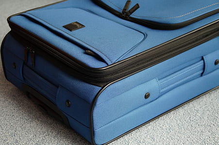blue and black luggage bag thumbnail