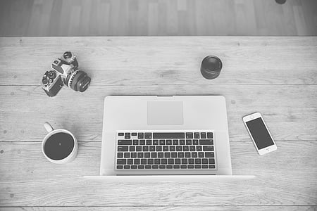 silver MacBook Air between silver iPhone 5s and white ceramic mug with beverage thumbnail