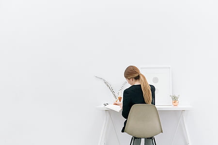 woman sitting on chair beside table thumbnail