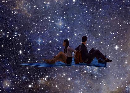 man and woman sitting on blue carpet thumbnail