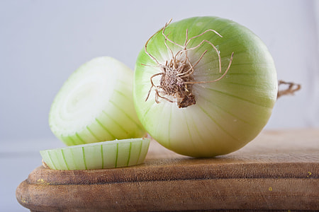 sliced white onions on brown chopping board thumbnail