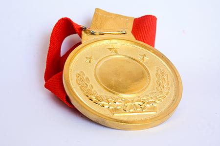 gold medal on white surface thumbnail