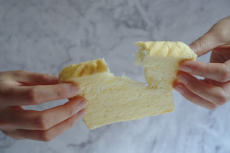 Person Holding Slice of Loaf Bread thumbnail