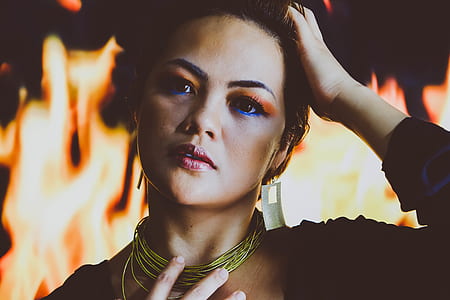 woman wearing black top and gold necklace thumbnail