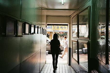 silhouette photo of woman walking towards road thumbnail