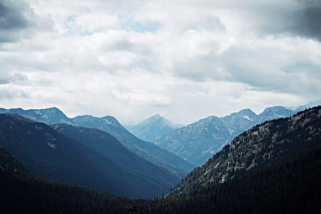 photography of mountains during cloudy skies thumbnail