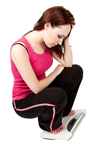 woman wearing pink tank tank and black pants on digital personal scale thumbnail