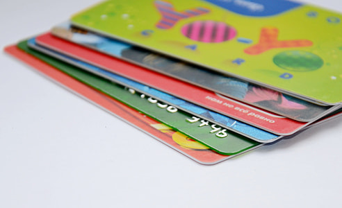 six assorted-color smart cards on white surface thumbnail