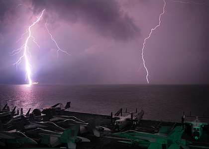 warm wave ocean under lightning at nighttime thumbnail