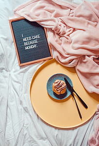 muffin on blue saucer near pink textile thumbnail