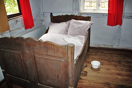 brown wooden bed frame with headboard beside white container thumbnail