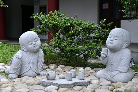 Buddha sitting on stone and holding cup statue thumbnail