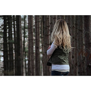 woman wearing green top surrounded by trees thumbnail