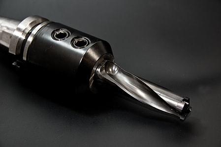 gray drill chuck with drill bit closeup photo thumbnail