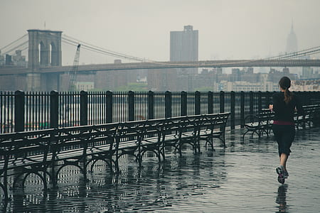 woman in black shirt running near bench thumbnail