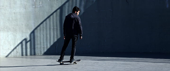 man in black jacket on black skateboard thumbnail
