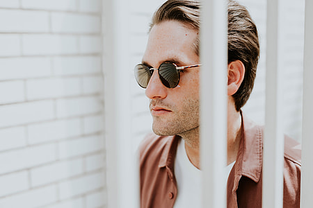 man in brown button-up shirt and white crew-neck shirt thumbnail