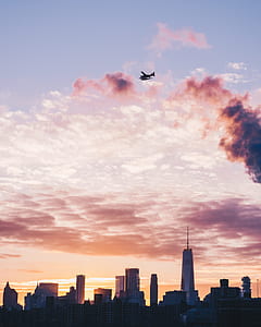 plane flying above city during golden hour thumbnail