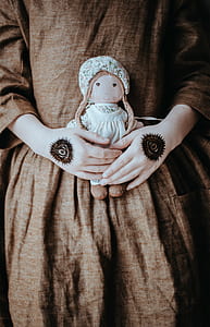 person holding doll thumbnail