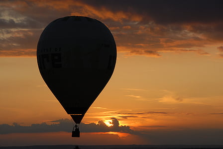 person riding hot air balloon during golden hour thumbnail