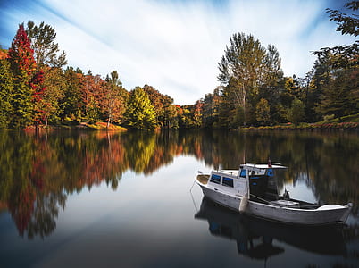 white and blue boat on body of water during daytime thumbnail