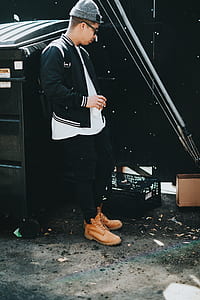 man leaning on black dumpster thumbnail
