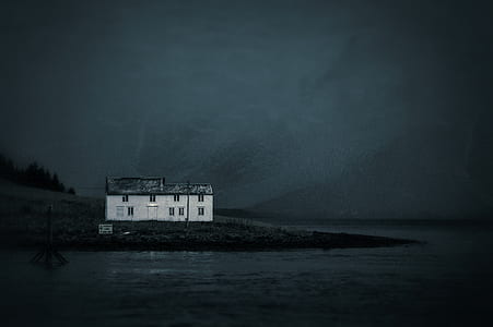white painted house near body of water at nighttime thumbnail