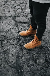 person in brown suede work boot and black skinny jeans thumbnail