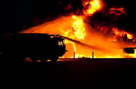 silhouette photo of fire truck trying to put the fire out thumbnail