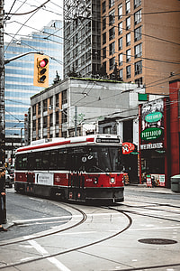 red and white train on gray road thumbnail