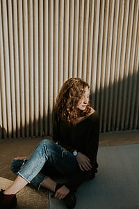 woman sitting on floor near wall thumbnail