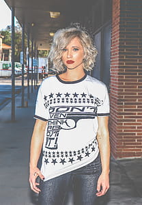 Woman in White and Black Gun-printed Crew-neck Shirt thumbnail