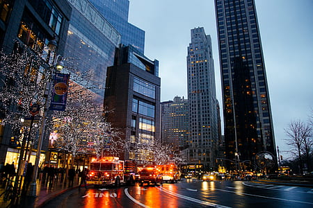 vehicles on road near high rise buildings at daytime thumbnail
