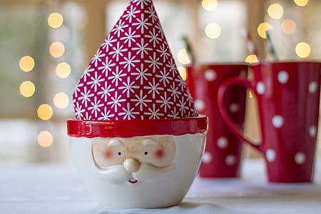 selective focus photography of Santa Claus ceramic mug near two ceramic mus thumbnail