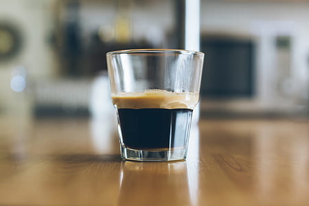 clear drinking glass on top of brown wooden table thumbnail