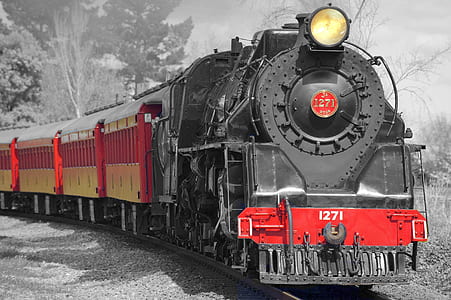 selective color photography of black and red train thumbnail