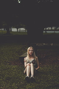 woman sitting on green grass thumbnail
