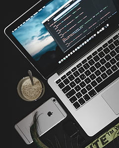 silver MacBook Pro beside space gray iPhone 6s thumbnail