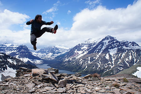 man jumping on top of mountain thumbnail