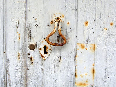 white metal door lock and white wooden door thumbnail